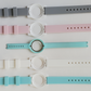 Comparison of teal, white, pink and gray color watch bands with original ripped Ava band.